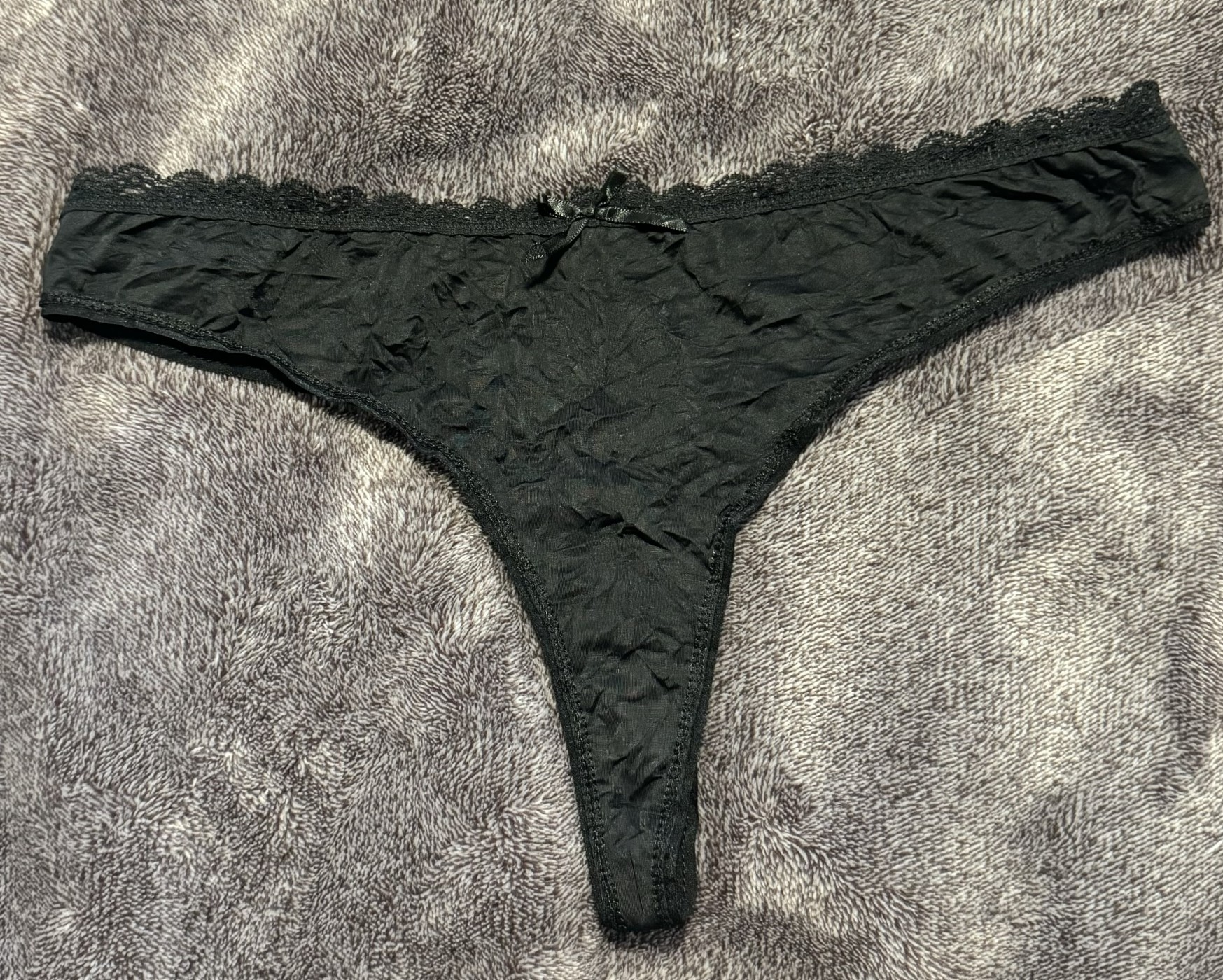 Worn black silky thong